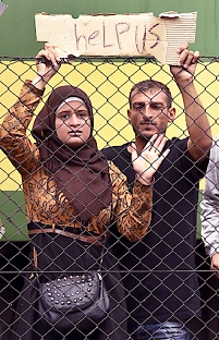 Refugees hold up a sign at the Railway Station in Bicske, Hungary, early 04 September 2015.